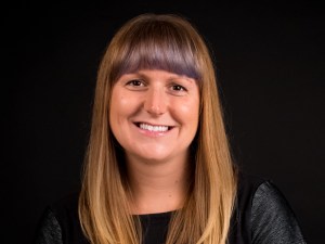 Head shot of young woman on black