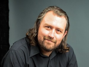 Head shot of young man on gray