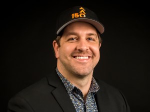 Head shot of young man on black